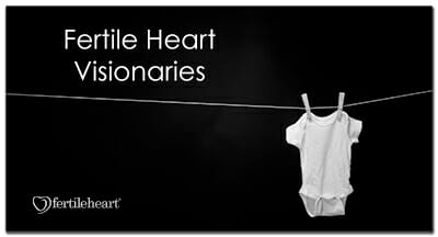 Baby's onesie hanging on clothesline Fertile Heart Visionaries
